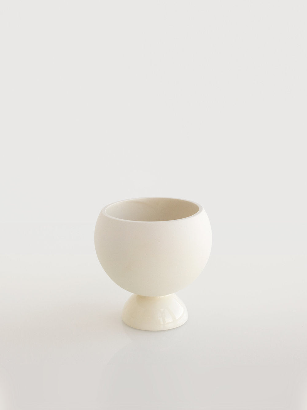Empty cova vase in matte white porcelain with glazed interior and base