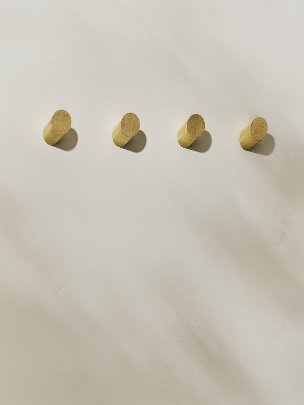 4 brushed brass parallax wall hooks