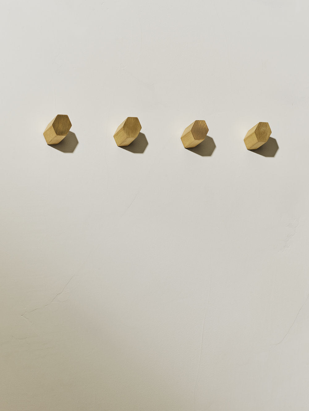 4 hexagonal brushed brass parallax wall hooks